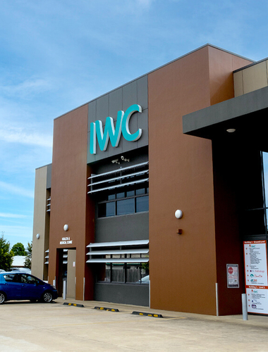 IWC Building stands tall with blue sky behind