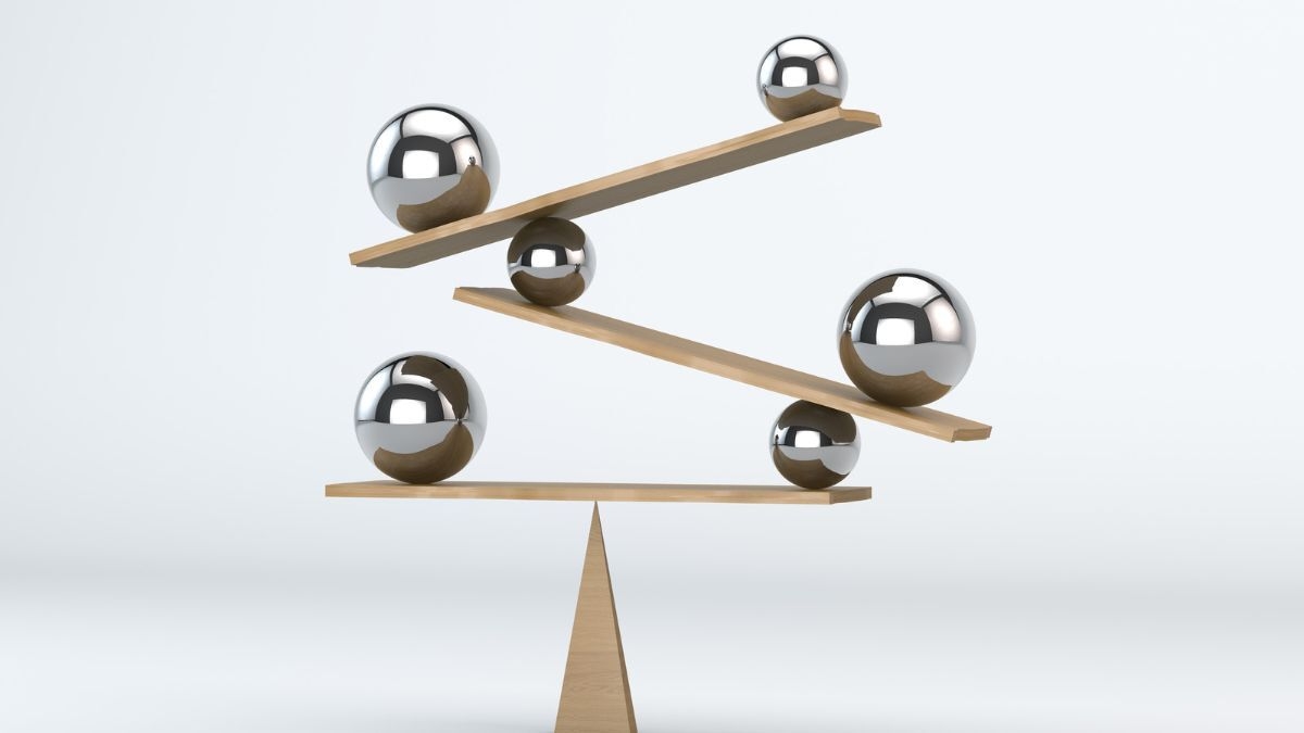 series of balls balance on wooden planks